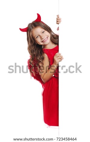 Happy girl wearing devil halloween fancy dress holding the blank board closeup picture