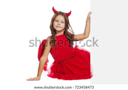 Horizontal picture of a girl halloween devil  holding the blank board sitting in a white studio