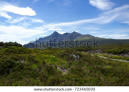 Centered peaks and hiking trail visible in a magnificent landscape of the Cuillin Mountains and Tir Nan Iolaire or Land of Eagles on the Isle of Skye in Scotland.