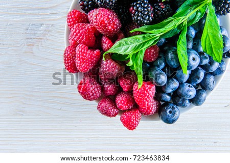 Various fresh summer berries,blueberries, raspberries and black berries shot from above..
