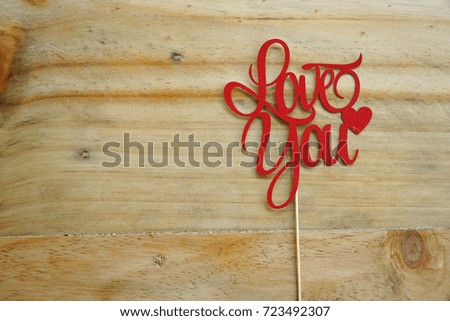 Top or flat lay view of Photo booth props a Red text Love You on a wooden background flat lay. Birthday parties and weddings.             