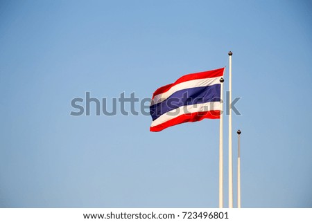 Thailand flag waving by the wind on the blue sky background