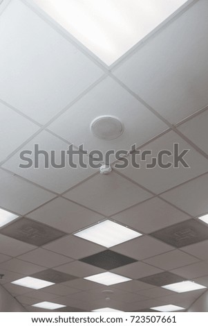 Office room ceiling with smoke detector and alarm