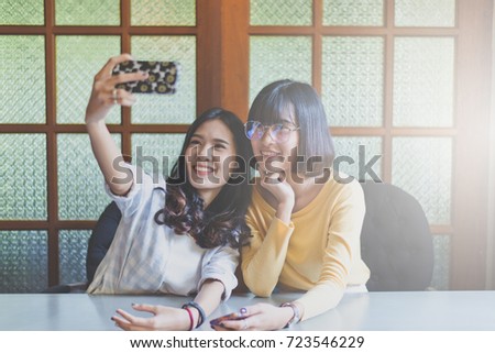 Portrait a beautiful asian teen woman smiling,happy,fun and selfie with her smartphone
