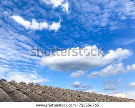 Beautiful blue sky and very big white cloud  on old tile roof in summer day