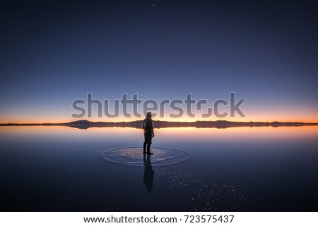 A Man Seeing Sunrise at Salt Flat, Salar de Uyuni, Bolivia