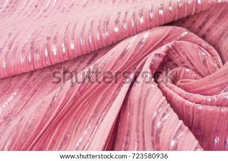 Texture, fabric, background. The hippo's skin is pink in color, the strips are white shiny, silvery polski, golden.