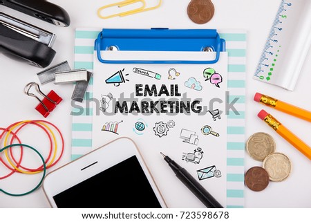 Email Marketing concept. Office desk with stationery and mobile phone