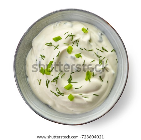 Bowl of sour cream dip sauce with herbs isolated on white background, top view Royalty-Free Stock Photo #723604021