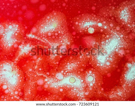 Many red oil bubbles mixed in water