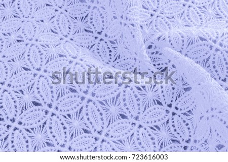 Image texture background, decorative lace with pattern. Blue pastel colors of lace fabric. Template for wedding, invitation or greeting card with blue lace background. Close-up of a wedding lace