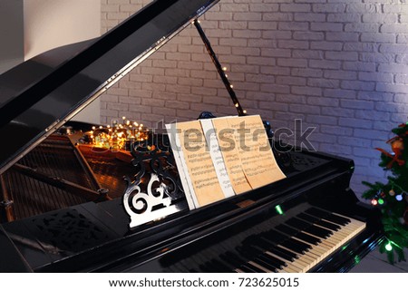 Piano with music sheets in room. Christmas concept