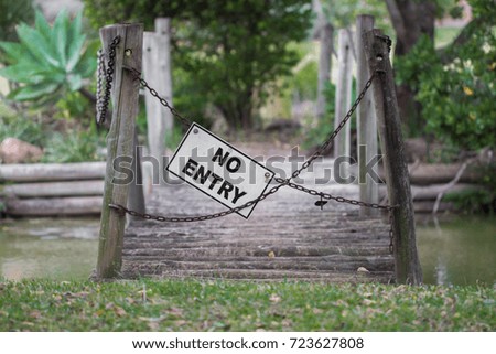 No entry across a bridge to a park.