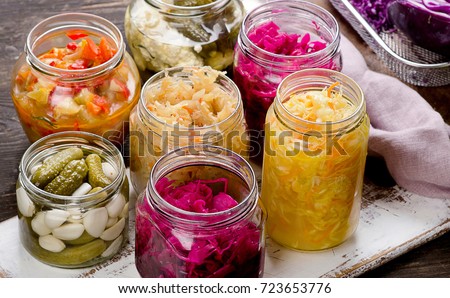Fermented vegetables in jars. Vegetarian food concept Royalty-Free Stock Photo #723653776