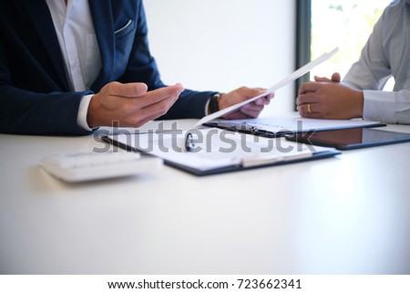 Sales manager giving advice application form document, considering mortgage loan offer for car and house insurance Royalty-Free Stock Photo #723662341