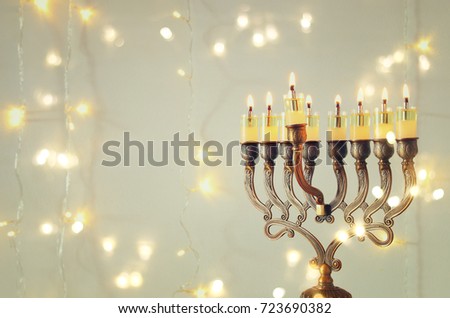 Image of jewish holiday Hanukkah background with menorah (traditional candelabra) and burning candles.