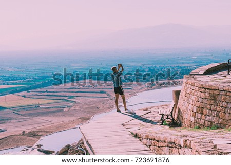 Unidentified man take selfie at Pamukkale (Cotton Castle) that is popular with Travertine pools and terraces  where people love to visit in Pamukkale, Turkey.
