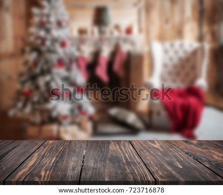 image of wooden table in front of christmas blurred background of interior. can be used for display or montage your products. Mock up for display of product.