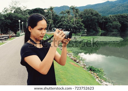 young girl photographer taking photos nature landscape in the holiday