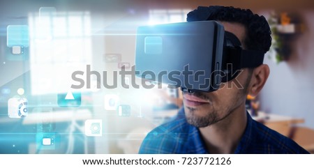 Close up of businessman looking though virtual reality simulator against futuristic app icons floating in light