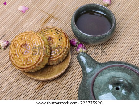 Moon cakes and tea cups and teapots on the table