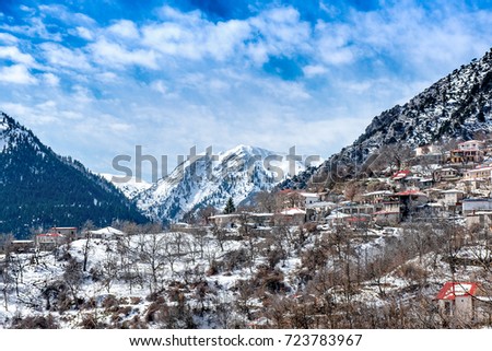 Snowy landscape. Winter with snow on a greek village at lake Plastira. Central Greece