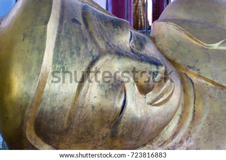 Close up face of large Reclining Buddha KYAUK HTAT GYI or call sweet eye Buddha  Yangon,Myanmar