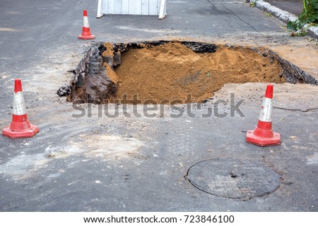 The road repair and caution with blocked barrier over concrete digging.