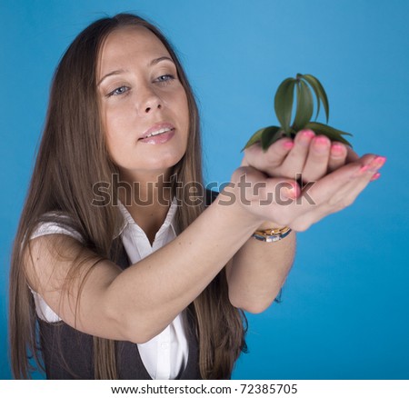 stock photo portrait of smiling woman holding plant in her hand