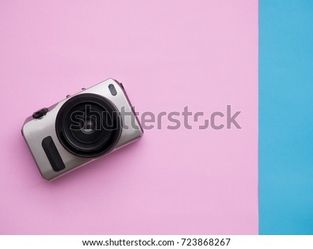 Camera mog-up on pink and blue background