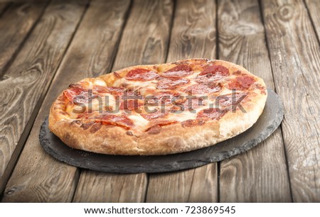 pizza pepperoni on wooden table close up