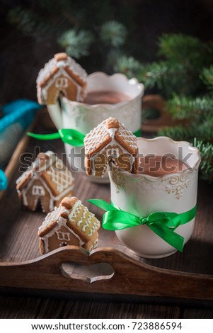 Aromatic gingerbread cottages with sweet drink as Christmas snack