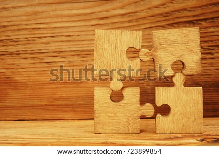 puzzles on wooden table background.Puzzle on wooden table, close up.Closeup of many jigsaw puzzles on wood texture.business idea,Game concept,connection sign, team symbol                              