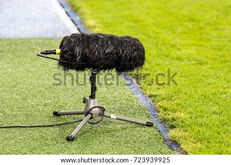 Furry sport microphone on a soccer field