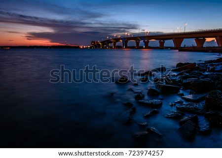 Sunset at the Hathaway Bridge connecting Panama City and Panama City Beach, Florida. Royalty-Free Stock Photo #723974257