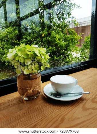 Coffee cup and saucer on a wooden table. nature background