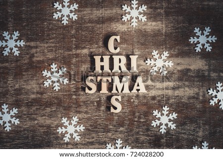 Christmas word made of wooden letters as christmas tree on a wooden background. Top view. Vintage style.
