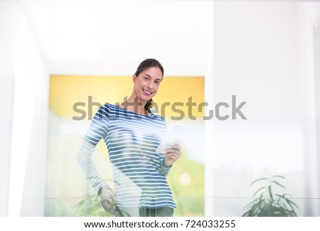 beautiful young woman at home websurfing on internet with tablet
