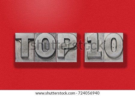 top ten metallic letterpress numbers assembled on red textured background
