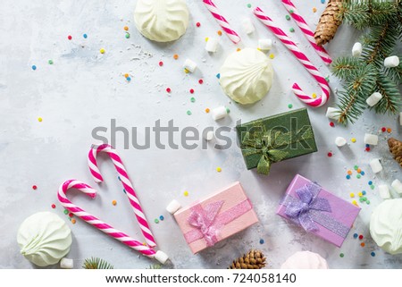 Christmas background with a present and festive decorations on a stone background. Top view with a copy.