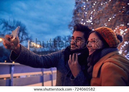 Couple Taking Selfie Near Ice Rink