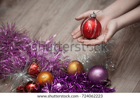 hands holding Christmas toy ball