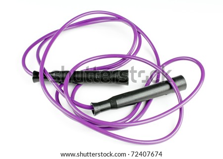 Purple jump rope tossed onto a white background after exercising. Royalty-Free Stock Photo #72407674