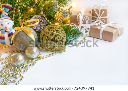 Christmas and New Year's background. A branch of a Christmas fir-tree with garlands, gifts, spheres, toys and decorating for a Christmas tree. A festive background with confetti of stars and bulbs.