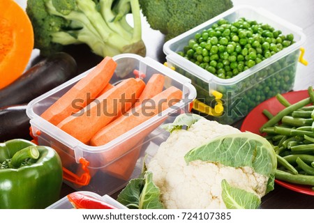 Trays box with vegetables for freezing. Stocking up for winter storage in plastic containers