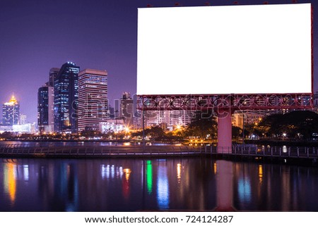 Blank billboard with light of urban and lake in the night - can advertisement for display or montage product or business concept