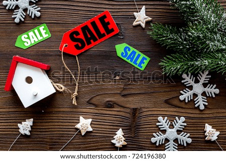 Christmas sale. Sale labels near spruce branch and xmas toys on wooden background top view copyspace