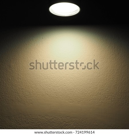 Warm light on the cement wall as backgrounds texture with text space.