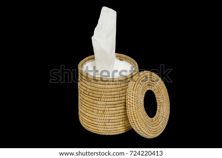 Wicker tissue box and cylindrical paper are isolated on black background with clipping path
