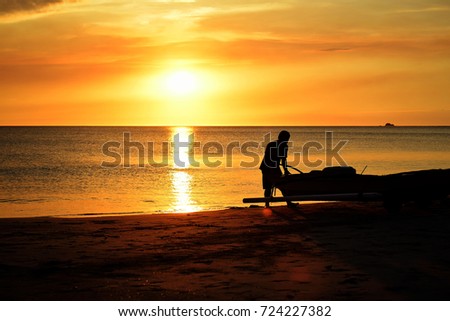 silhouette of fisherman boat with sunset background
